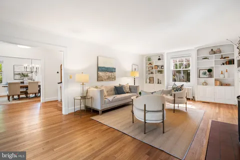 a living room with fireplace furniture and a large window