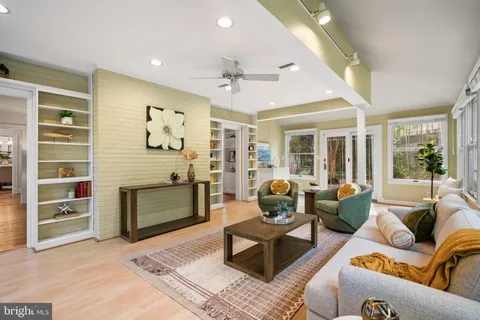 a dining room with furniture a chandelier and wooden floor