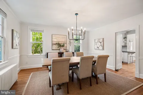 a living room with furniture a fireplace a lamp and a large window