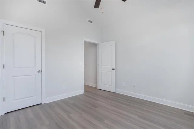 a bathroom with a granite countertop sink a toilet and shower