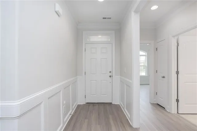 a view of a hallway with wooden floor