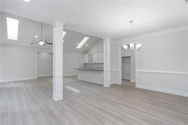 a view of a kitchen with wooden floor and a kitchen
