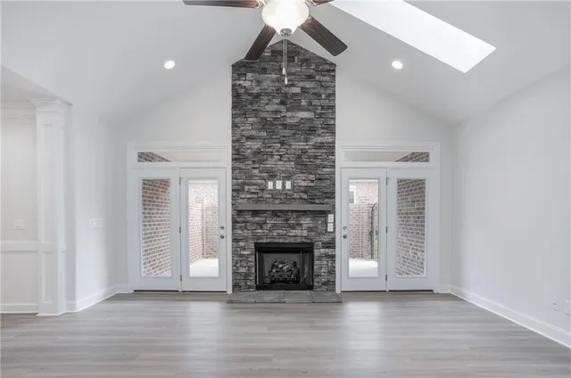 a living room with a fireplace and wooden floor