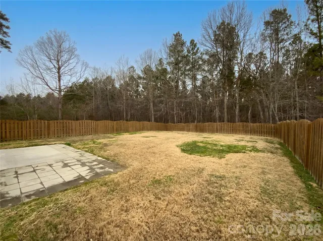 a swimming pool with an outdoor space and seating area