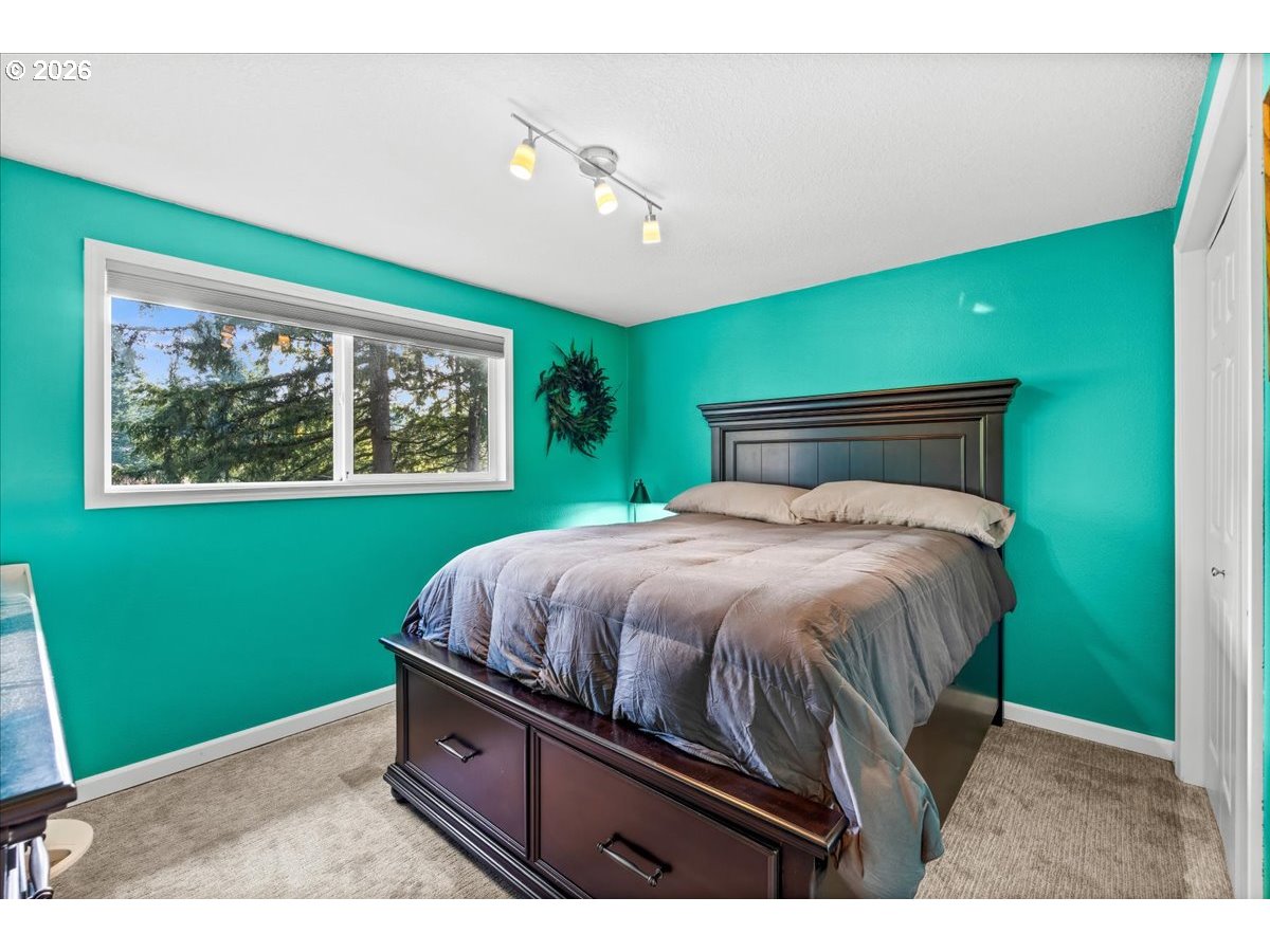 17110 South Potter Road Oregon City, OR 97045 - Photo 14 of 46 a bedroom with a bed and a window
