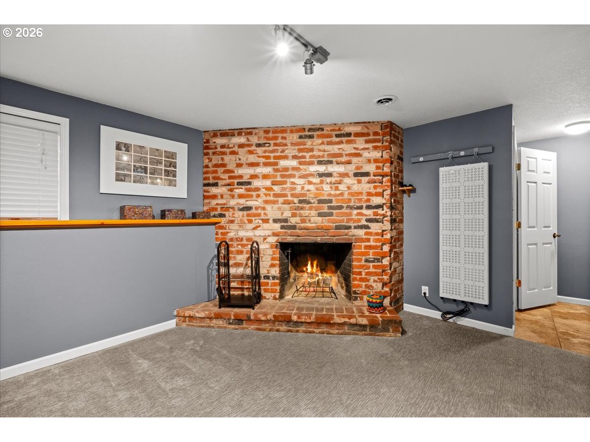 17110 South Potter Road Oregon City, OR 97045 - Photo 18 of 46 a room with a fireplace and a table