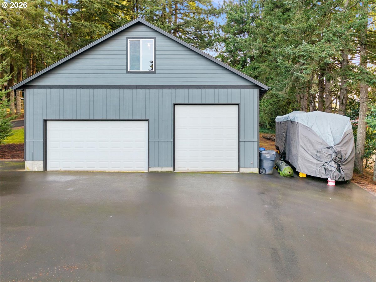 17110 South Potter Road Oregon City, OR 97045 - Photo 37 of 46 a view of a house with a garage and yard