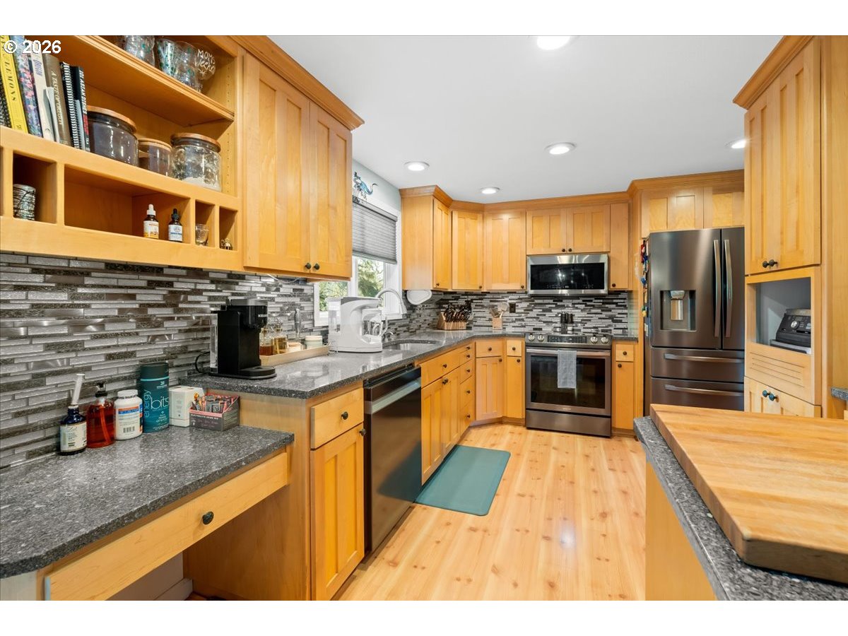 17110 South Potter Road Oregon City, OR 97045 - Photo 9 of 46 a kitchen with stainless steel appliances granite countertop a refrigerator a stove and a sink