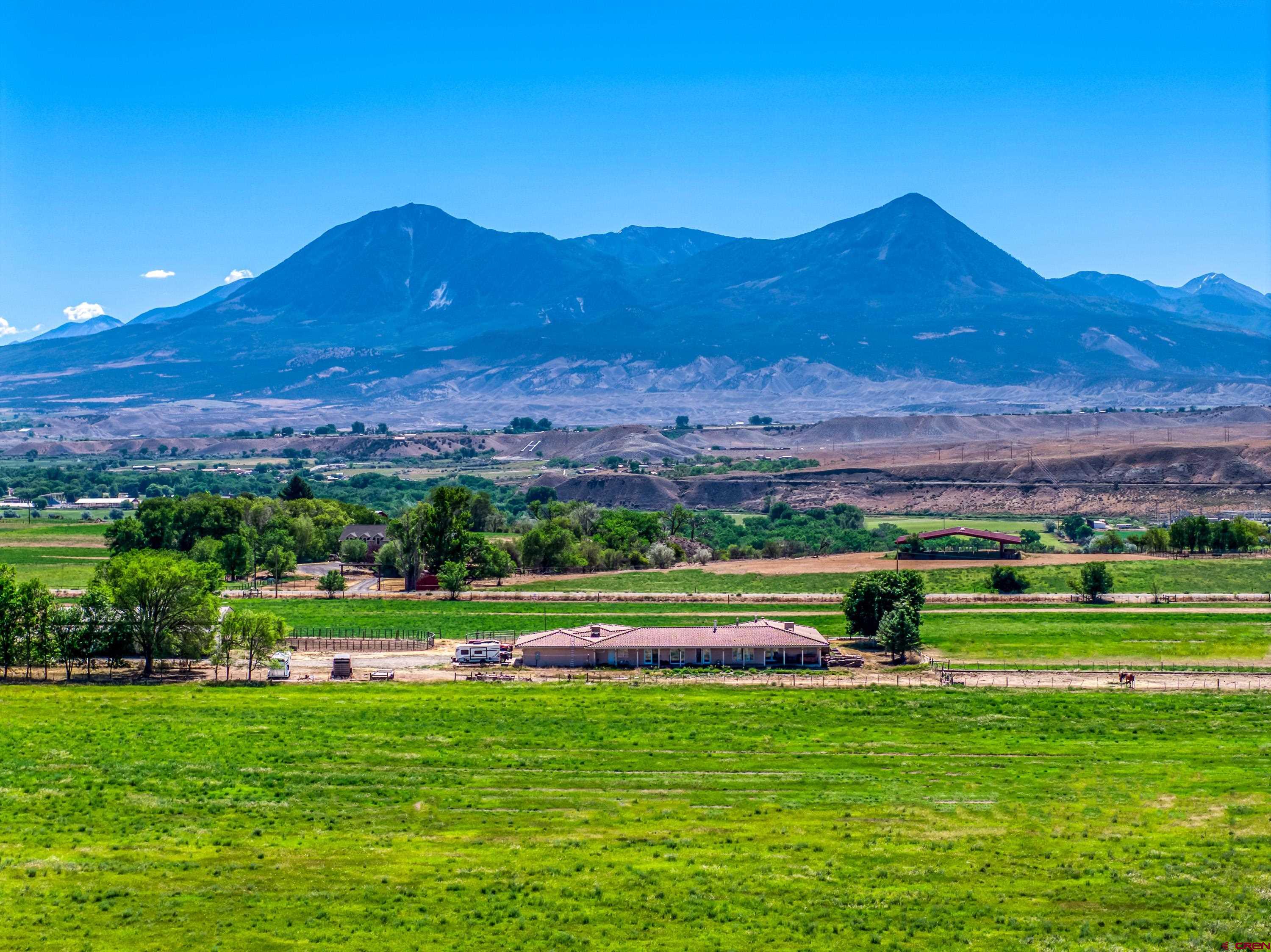 33059 J Road Hotchkiss, CO 81419 - Photo 38 of 44 a view of green field with mountains in the background