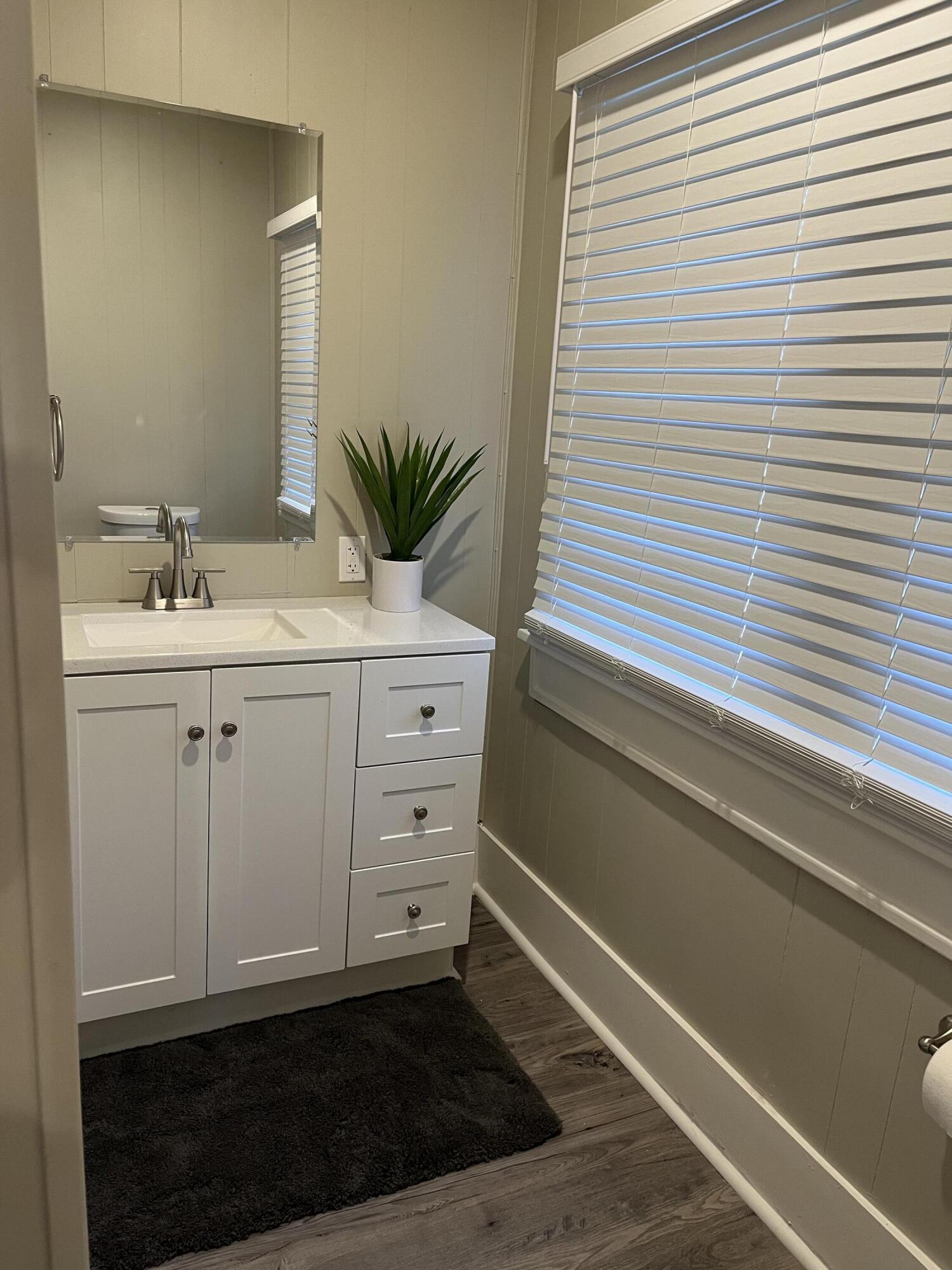 605 South 10th Street Slaton, TX 79364 - Photo 8 of 19 a bathroom with a sink and a mirror