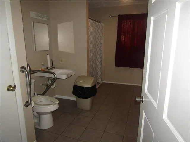 a bathroom with a toilet and a shower