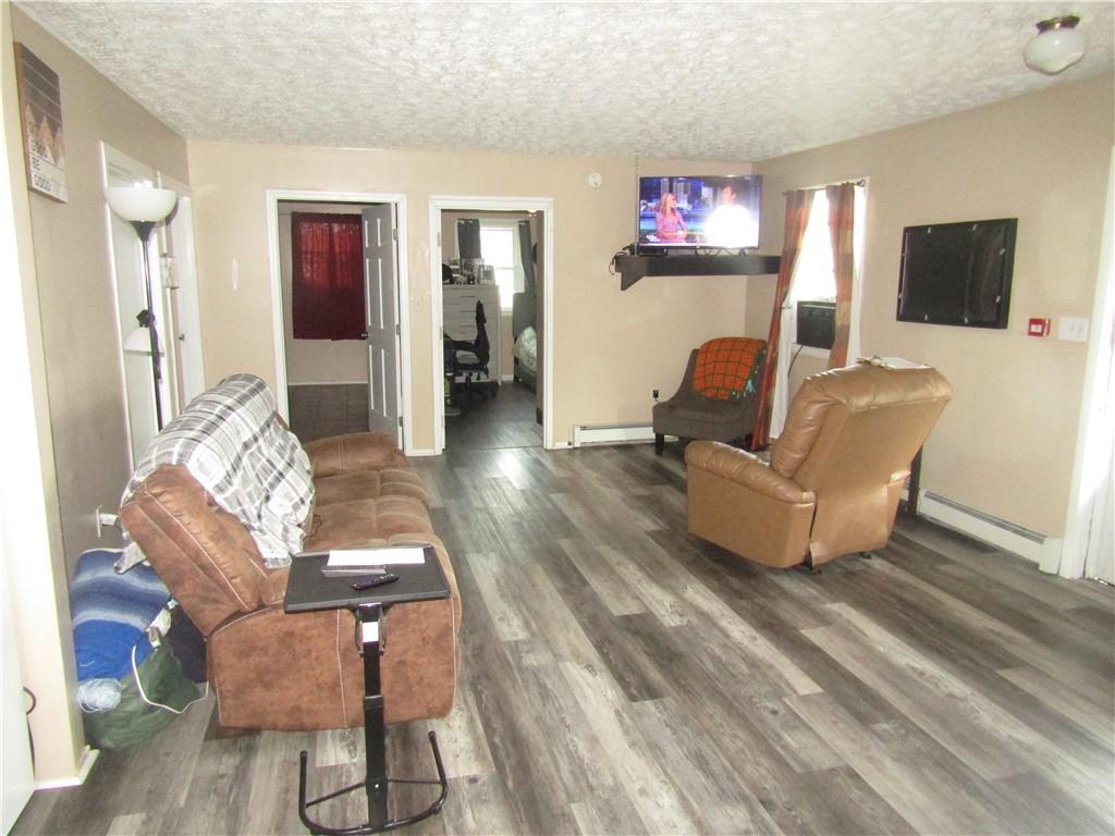 724 Stewart Street Berlin, PA 15530 - Photo 8 of 20 a living room with furniture and a flat screen tv