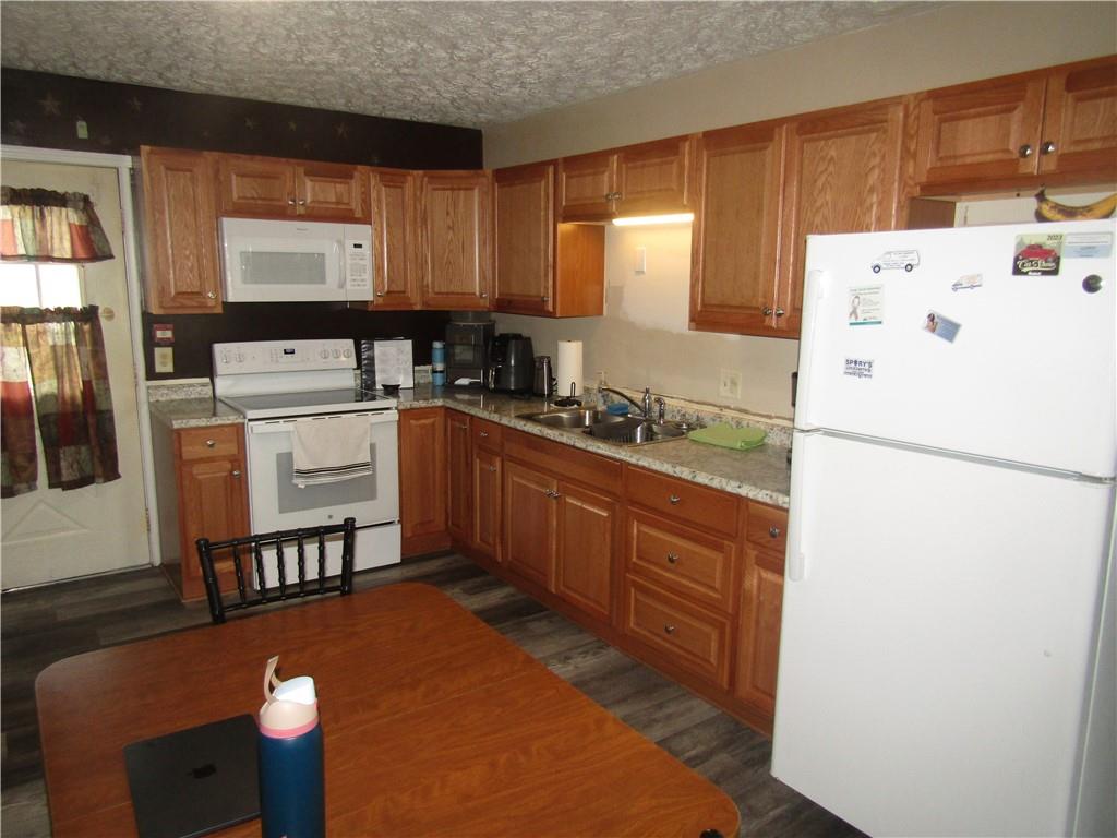 724 Stewart Street Berlin, PA 15530 - Photo 9 of 20 a kitchen with stainless steel appliances a refrigerator sink and white cabinets