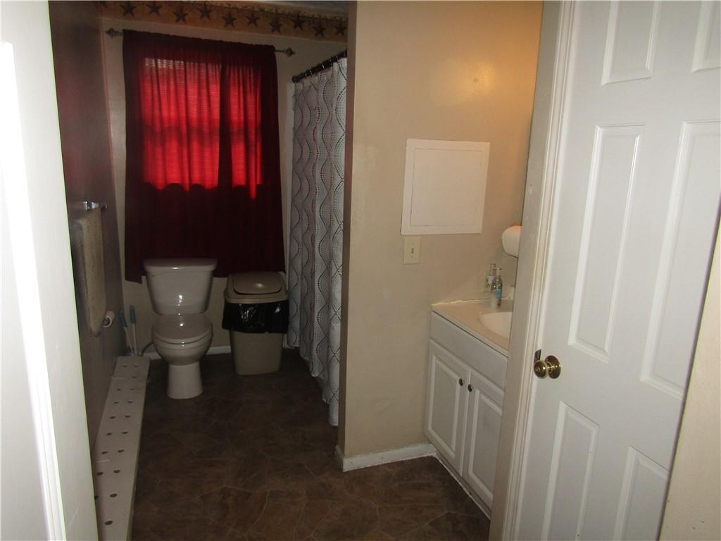 724 Stewart Street Berlin, PA 15530 - Photo 10 of 20 a bathroom with a granite countertop toilet and a sink