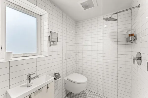 a bathroom with a toilet sink and mirror