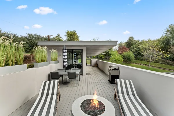 a view of balcony with furniture and garden