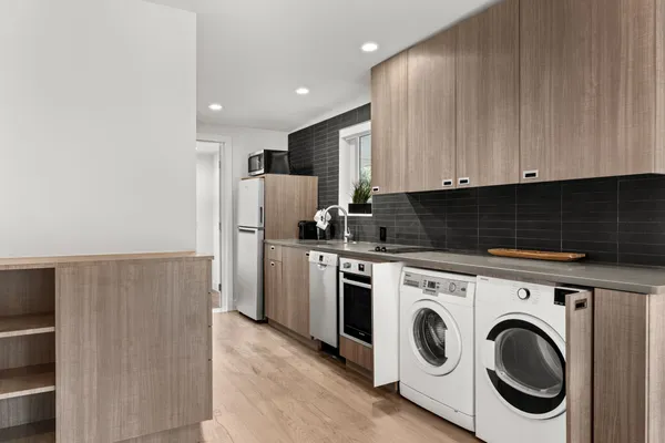 a kitchen with refrigerator and cabinets