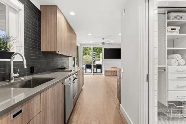 a kitchen with stainless steel appliances granite countertop sink stove and refrigerator