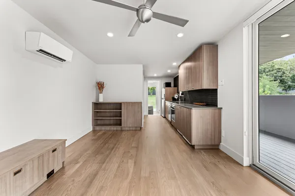 a kitchen with granite countertop a stove a sink and a refrigerator