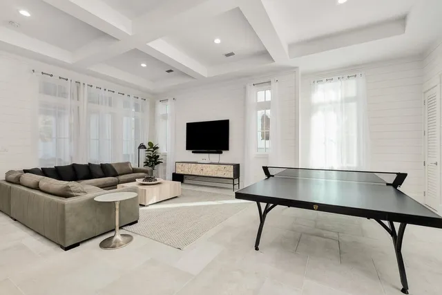 a view of a dining room with furniture one side kitchen view and wooden floor