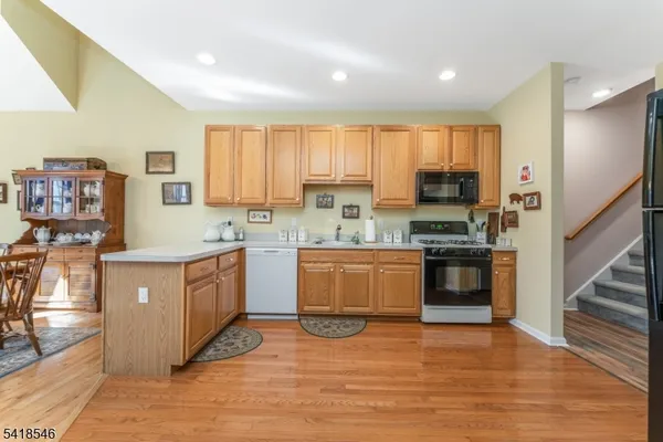 a kitchen with stainless steel appliances granite countertop a refrigerator sink and cabinets