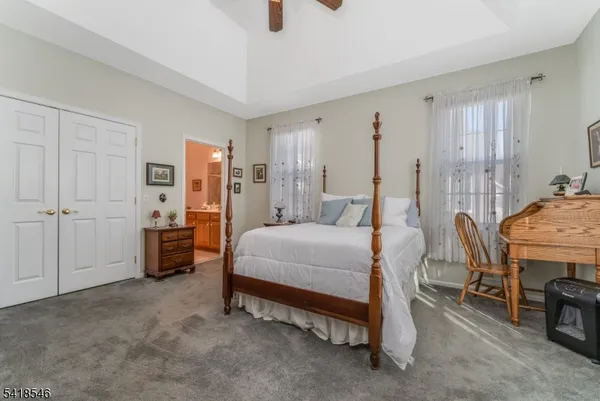 a bedroom with a bed and a table