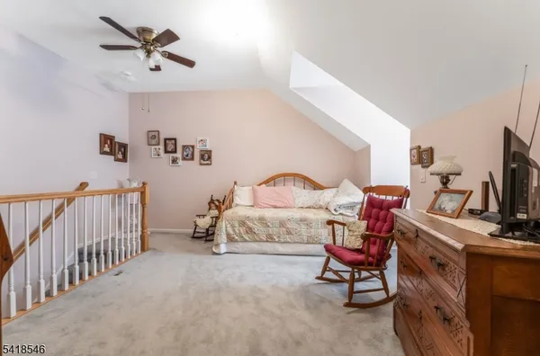 a bedroom with furniture and a tv
