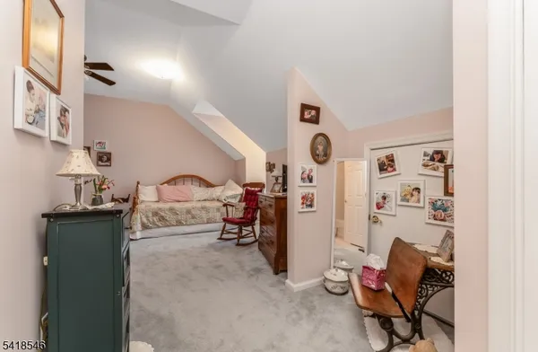 a bedroom with furniture and a lamp