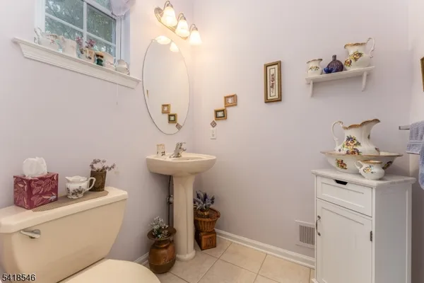 a bathroom with a sink toilet and a mirror
