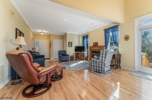 a living room with furniture a fireplace and a wooden floor