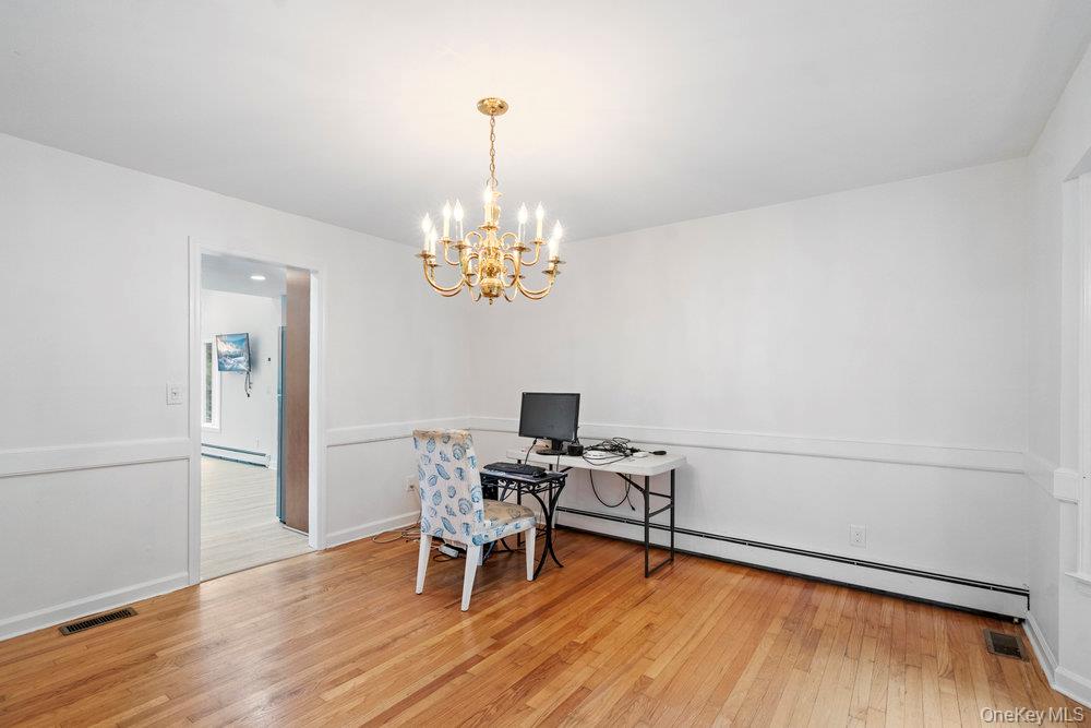 83 Shore Road Mount Sinai, NY 11766 - Photo 15 of 33 a view of a dining room with furniture wooden floor and chandelier