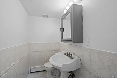 a bathroom with a sink mirror and toilet