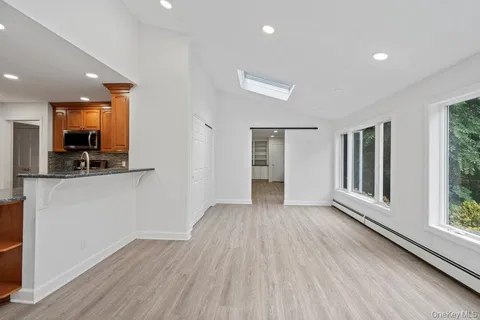 a view of a kitchen with a sink and a refrigerator