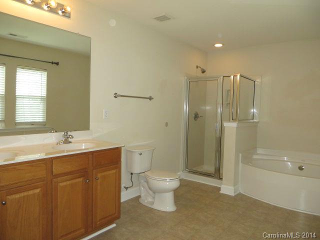 6644 Evanton Loch Road Charlotte, NC 28278 - Photo 14 of 24 a bathroom with a double vanity sink toilet mirror and shower