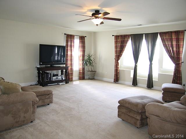 6644 Evanton Loch Road Charlotte, NC 28278 - Photo 16 of 24 a living room with furniture and a flat screen tv