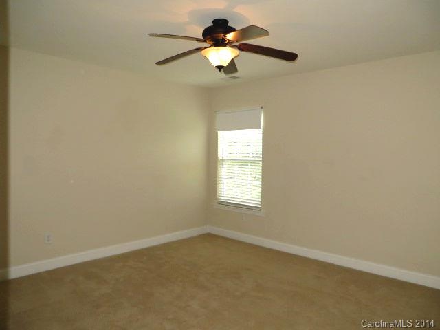 6644 Evanton Loch Road Charlotte, NC 28278 - Photo 18 of 24 an empty room with a window and a fan