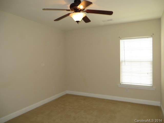 6644 Evanton Loch Road Charlotte, NC 28278 - Photo 19 of 24 an empty room with a window and a fan