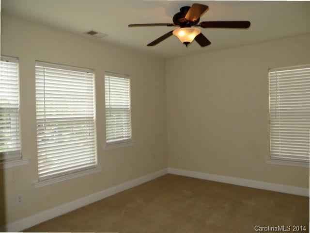 6644 Evanton Loch Road Charlotte, NC 28278 - Photo 20 of 24 an empty room with a window and a fan