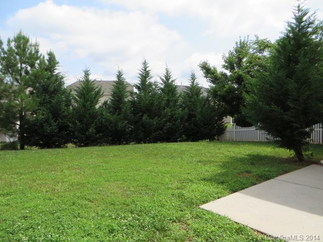 6644 Evanton Loch Road Charlotte, NC 28278 - Photo 22 of 24 a view of a field of grass and trees