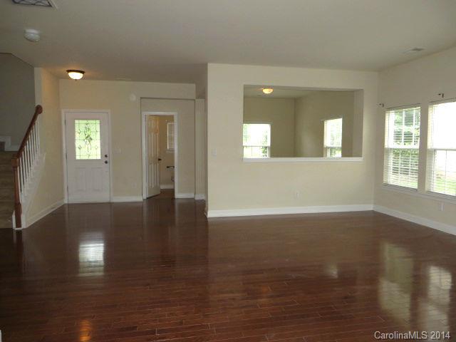 6644 Evanton Loch Road Charlotte, NC 28278 - Photo 4 of 24 a view of an empty room with wooden floor and a window