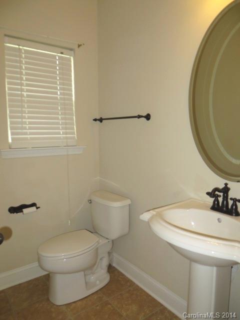 6644 Evanton Loch Road Charlotte, NC 28278 - Photo 5 of 24 a bathroom with a toilet a sink and a window