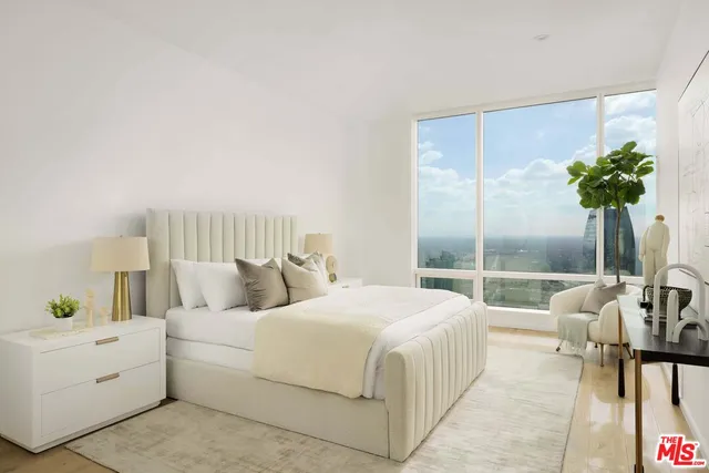 a bedroom with a bed and a potted plant