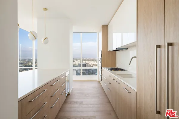 a kitchen with stainless steel appliances granite countertop a sink and cabinets