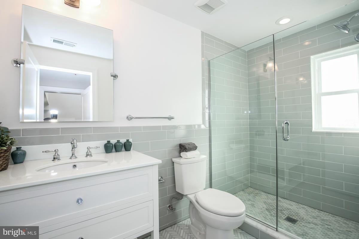 1514 8th Street Northwest, Unit 5 Washington, DC 20001 - Photo 5 of 15 a bathroom with a sink a toilet and shower