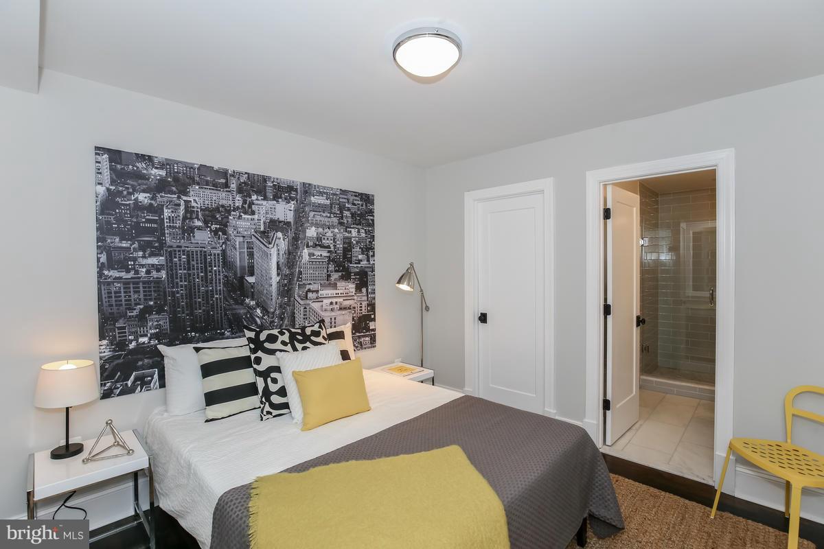 1514 8th Street Northwest, Unit 5 Washington, DC 20001 - Photo 6 of 15 a bedroom with a bed and a chandelier