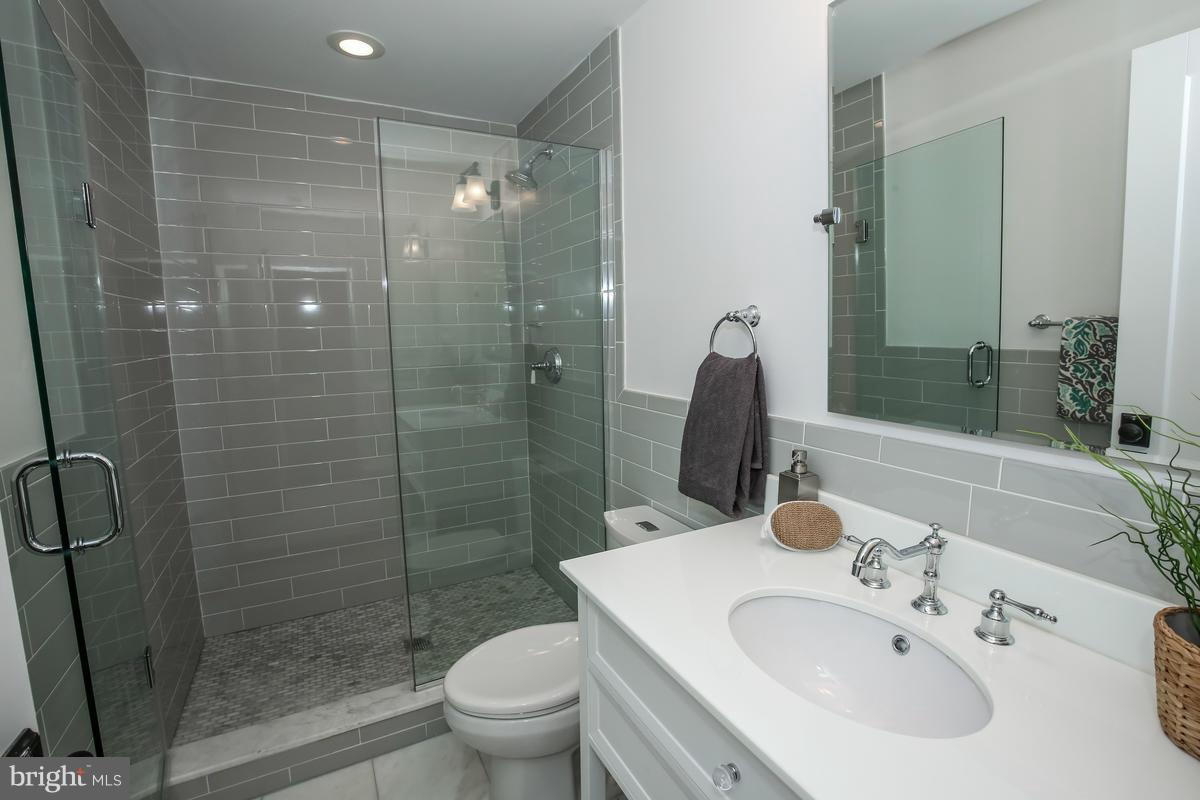 1514 8th Street Northwest, Unit 5 Washington, DC 20001 - Photo 7 of 15 a bathroom with a sink toilet and shower