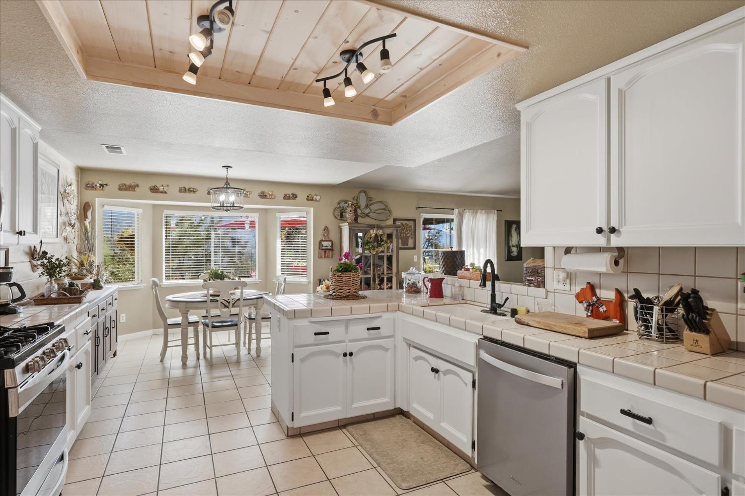 32583 River Knolls Road Coarsegold, CA 93614 - Photo 22 of 63 a kitchen with a sink and cabinets