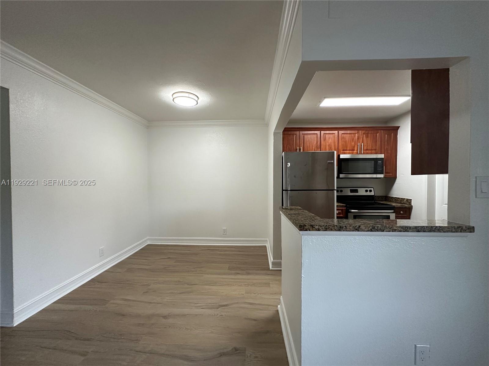 1400 Northeast 56th Street, Unit 105 Fort Lauderdale, FL 33334 - Photo 14 of 42 a view of a kitchen from the hallway