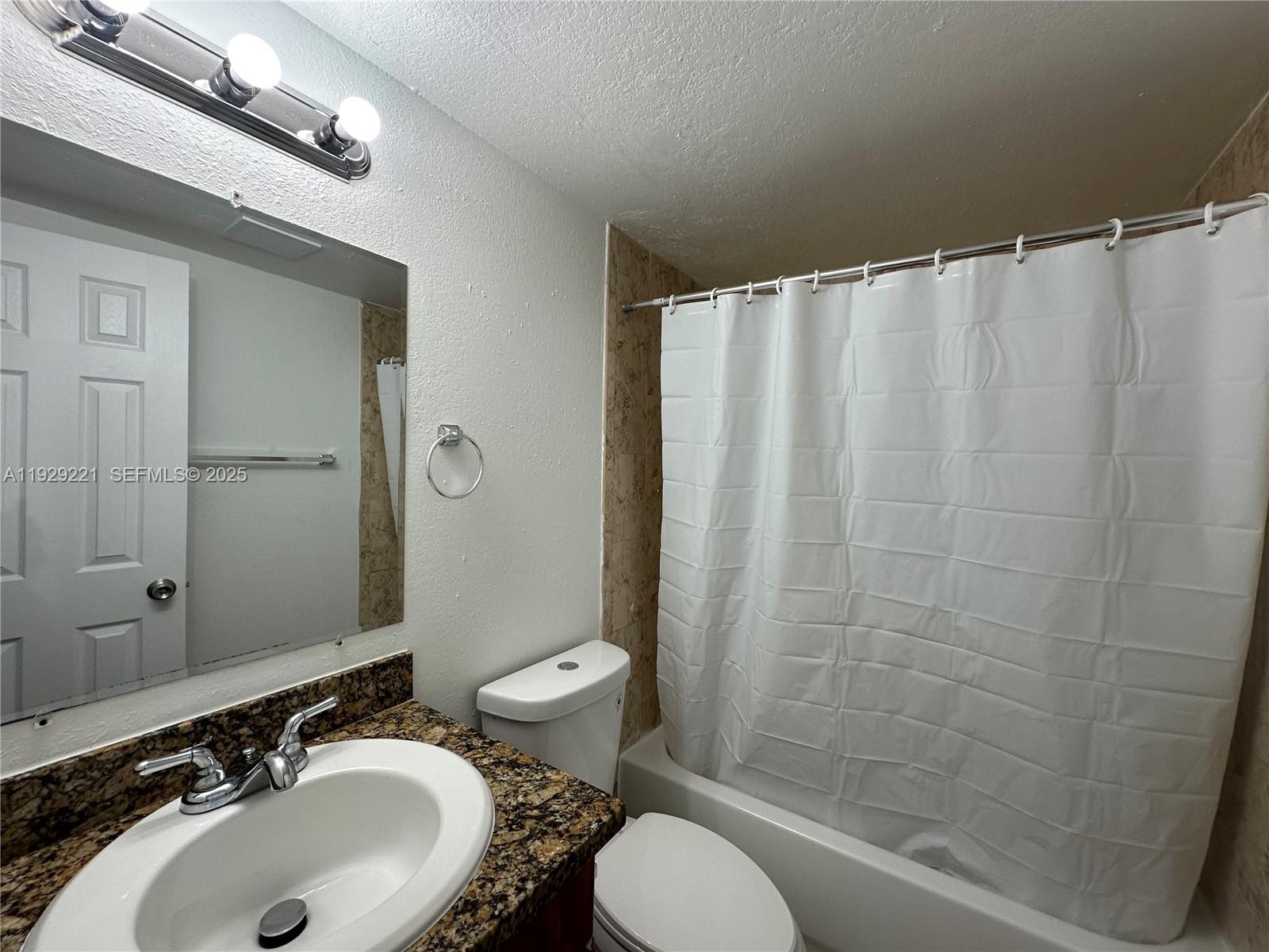 1400 Northeast 56th Street, Unit 105 Fort Lauderdale, FL 33334 - Photo 16 of 42 a bathroom with a sink toilet and shower