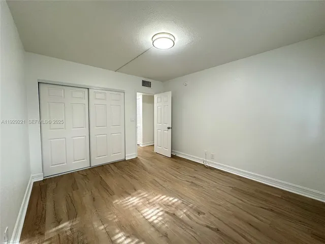 a view of an empty room and wooden floor